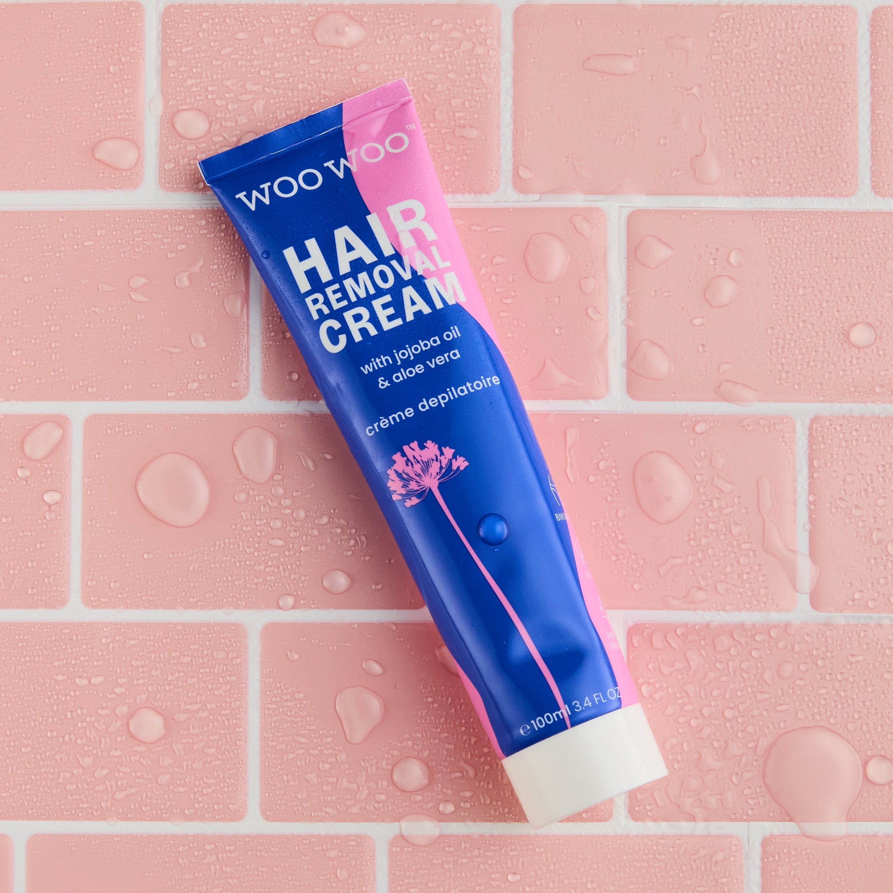 WooWoo Hair Removal Cream on pink splash tile