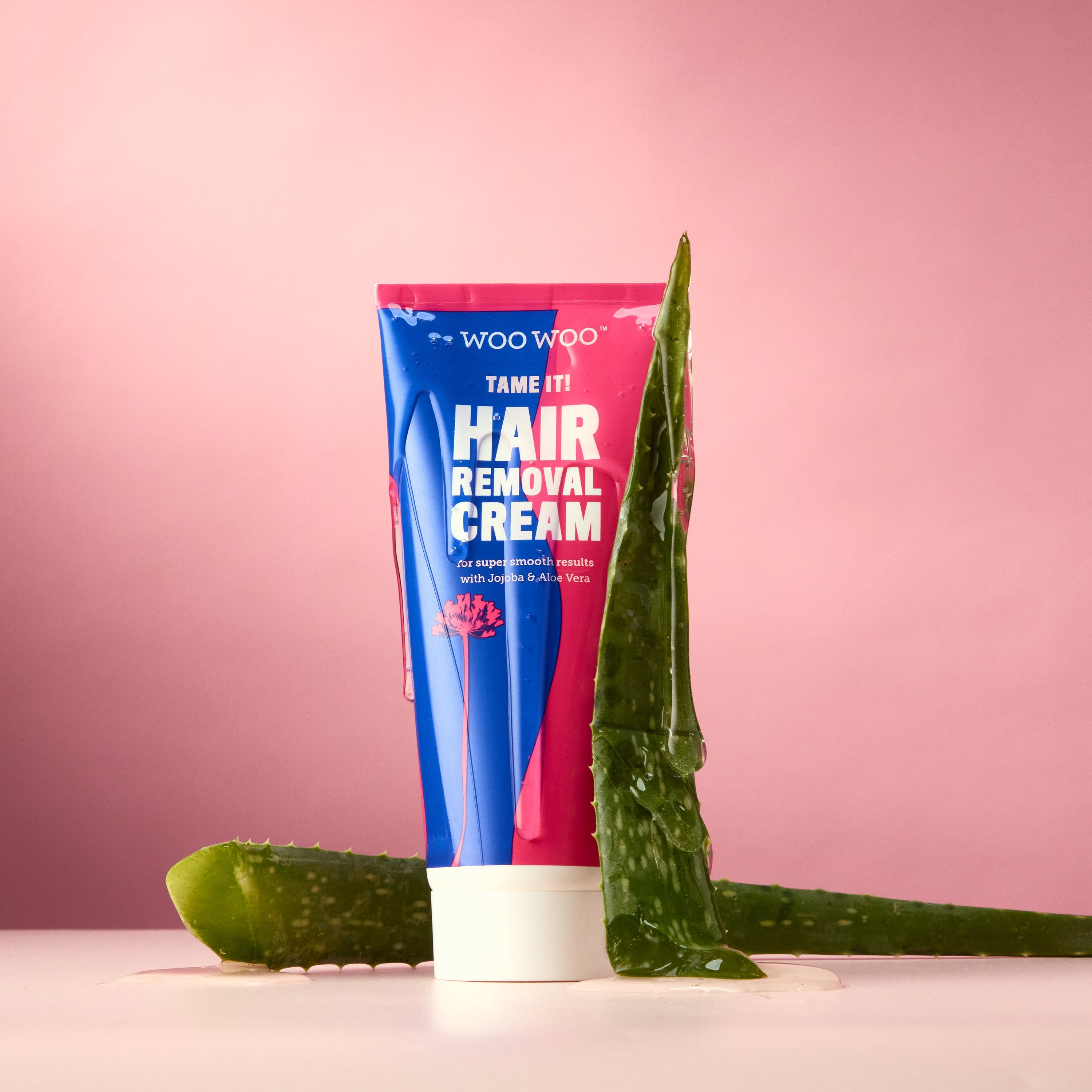 Photograph of WooWoo hair removal cream on pink background