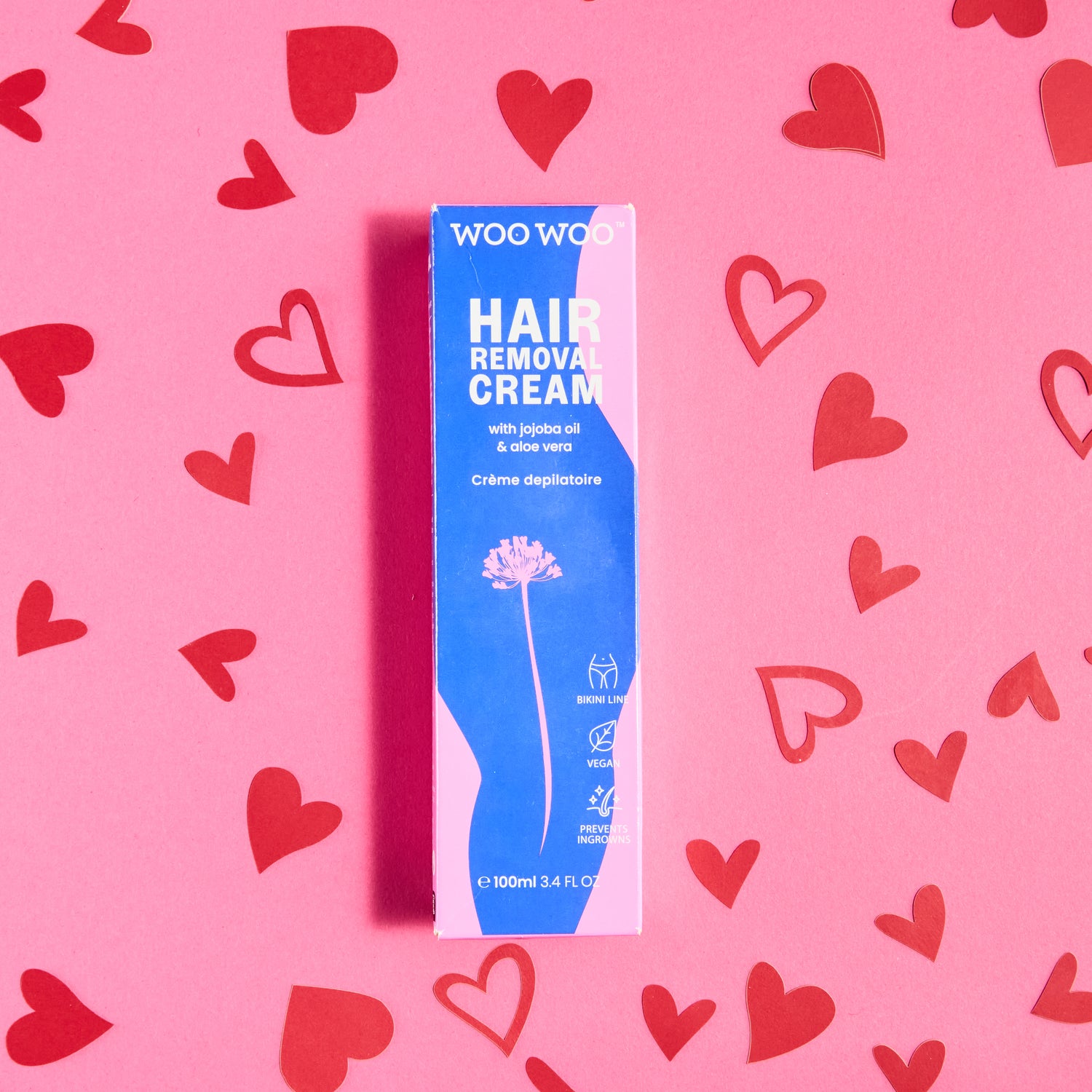 Woo Woo hair removal cream packaging on a pink background with red hearts