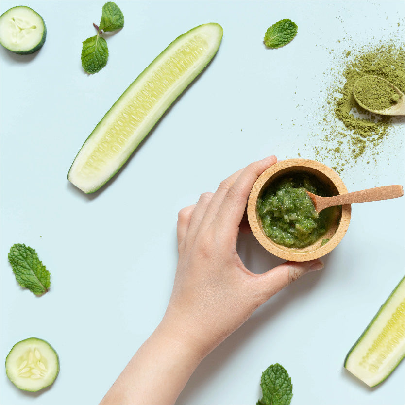 Photograph of cucumber and mint on a blue background